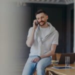 freelancer talking on phone while sitting on work blx665p