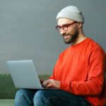 programmer using laptop computer typing on keyboar c6x6qcm