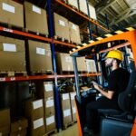 warehouse worker doing logistics work with forklif gpv9kcy.jpg