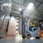 warehouse worker operates a forklift nrcb2se.jpg