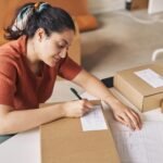 woman signing the box before shipping zc6epym.jpg